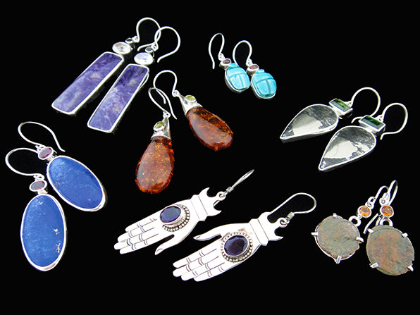 Assorted earrings made with stone cabachons and set in sterling silver with sterling silver ear wires.